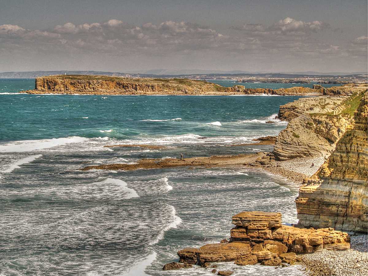 Die bizarr geformte Felsküste von Peniche in Portugal findet sich als ein „Best of“ im Kapitel „Die großartigsten Surfspots“ (Foto © Getty / Japatino)